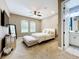 Bedroom with a light color scheme, en-suite bathroom, and neutral carpet at 31980 Geoff Way, Sorrento, FL 32776