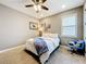 Inviting bedroom with a plush chair, neutral walls, and shutters that provide privacy and comfort at 31980 Geoff Way, Sorrento, FL 32776