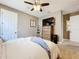 Well-lit bedroom featuring a ceiling fan, television, and neutral decor for a cozy and inviting atmosphere at 31980 Geoff Way, Sorrento, FL 32776