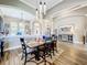 Elegant dining room with wood-look tile flooring, a modern pendant light, and stylish views of the open floorplan at 31980 Geoff Way, Sorrento, FL 32776