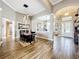 Elegant dining room with wood-look tile flooring, a modern pendant light, and stylish views of the open floorplan at 31980 Geoff Way, Sorrento, FL 32776