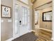 Elegant foyer with wood-look tile flooring, decorative glass door, and view into bedroom at 31980 Geoff Way, Sorrento, FL 32776