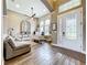 Bright foyer with high ceilings, wood-look tile, front door with decorative glass, and adjacent office at 31980 Geoff Way, Sorrento, FL 32776