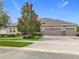 Charming single-story home with manicured lawn, lush landscaping and brick paved driveway at 31980 Geoff Way, Sorrento, FL 32776