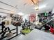 Large garage featuring gym equipment, organized storage and epoxy-coated floor at 31980 Geoff Way, Sorrento, FL 32776