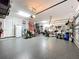 Garage with epoxy flooring, home gym, and extra refrigerator at 31980 Geoff Way, Sorrento, FL 32776