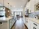 Modern kitchen with an island, stainless steel appliances, and stylish pendant lighting at 31980 Geoff Way, Sorrento, FL 32776