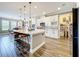 Spacious kitchen with a large island, white cabinets, tiled backsplash and a walk-in pantry at 31980 Geoff Way, Sorrento, FL 32776