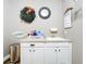 Charming laundry room with white cabinetry, sink and decorative wall hangings at 31980 Geoff Way, Sorrento, FL 32776