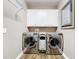 Laundry room with stainless steel washer and dryer and storage cabinet at 31980 Geoff Way, Sorrento, FL 32776