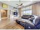 Open-concept living room featuring vaulted ceilings, large windows, and a built-in entertainment center at 31980 Geoff Way, Sorrento, FL 32776