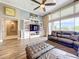 Spacious living room with tile floors, a media center, and neutral-toned walls and decor at 31980 Geoff Way, Sorrento, FL 32776
