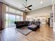 Bright living room with a large sliding glass doors, tile floors, and an open view to the kitchen at 31980 Geoff Way, Sorrento, FL 32776