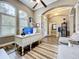 Inviting living room featuring high ceilings, a ceiling fan, tile floors, and a decorative doorway at 31980 Geoff Way, Sorrento, FL 32776