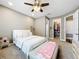 Cozy main bedroom features a walk-in closet, neutral tones, and a ceiling fan at 31980 Geoff Way, Sorrento, FL 32776