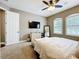 Relaxing main bedroom with neutral tones, plantation shutters and a ceiling fan at 31980 Geoff Way, Sorrento, FL 32776