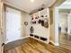 Mudroom with built-in storage, bench seating, and wood-look tile floors for added convenience at 31980 Geoff Way, Sorrento, FL 32776