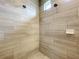 Beautiful walk-in shower with a tiled walls, multiple shower heads, and a built-in soap dish at 31980 Geoff Way, Sorrento, FL 32776