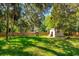 Large backyard with mature trees, well, and partial fencing at 370 Hand Ave, Ormond Beach, FL 32174