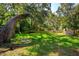 Large backyard with mature trees and partial fencing at 370 Hand Ave, Ormond Beach, FL 32174