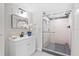 Modern bathroom features a glass-enclosed shower, sleek fixtures, and stylish vanity with ample storage at 370 Hand Ave, Ormond Beach, FL 32174