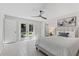 Bright bedroom with double doors to the backyard, comfortable bed, and stylish decor at 370 Hand Ave, Ormond Beach, FL 32174