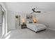 Serene bedroom with a comfortable bed, stylish decor, and a door leading to the outside at 370 Hand Ave, Ormond Beach, FL 32174