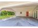 Covered carport with a red front door and additional storage space at 370 Hand Ave, Ormond Beach, FL 32174