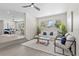 Bright and airy living room with modern decor, ceiling fan, and ample natural light at 370 Hand Ave, Ormond Beach, FL 32174