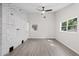 Spacious living room with painted brick wall, wood-look floors, and natural light at 370 Hand Ave, Ormond Beach, FL 32174