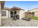 A cozy back patio features unique mosaic tiling and a convenient grilling area at 3702 Starks St, Orlando, FL 32805