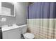 Cozy bathroom with modern sink, toilet, and shower with striped curtain at 3702 Starks St, Orlando, FL 32805