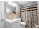 Compact bathroom with vanity and decorative shower curtain and standard fixtures at 3702 Starks St, Orlando, FL 32805