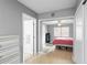 Cozy bedroom featuring wood floors, gray walls, and natural light from the window at 3702 Starks St, Orlando, FL 32805