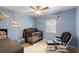 Cozy bedroom featuring a crib, ceiling fan, and soft blue walls, perfect for a Bedroom at 3702 Starks St, Orlando, FL 32805