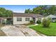 View of house with a long driveway, grassy lawn, and charming curb appeal at 3702 Starks St, Orlando, FL 32805