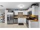 Updated kitchen boasting stainless steel appliances, tile backsplash, and ample storage space at 3702 Starks St, Orlando, FL 32805