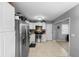 Well-lit kitchen featuring stainless steel appliances, white cabinets, and tile flooring throughout at 3702 Starks St, Orlando, FL 32805