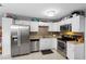 Updated kitchen boasting stainless steel appliances, tile backsplash, and ample storage space at 3702 Starks St, Orlando, FL 32805