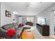 Open-concept living room with contemporary furniture, neutral color scheme, and abundant sunlight at 3702 Starks St, Orlando, FL 32805