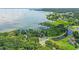Scenic aerial view showcasing a waterfront community with lush trees and lake access at 400 Timbercreek N Dr, Winter Garden, FL 34787