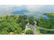 Picturesque aerial view of a waterfront community with lush trees and serene lake at 400 Timbercreek N Dr, Winter Garden, FL 34787
