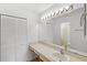 Bathroom with a long vanity, large mirror, and white cabinets at 400 Timbercreek N Dr, Winter Garden, FL 34787