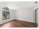 Bedroom featuring wood floors and an arched window at 400 Timbercreek N Dr, Winter Garden, FL 34787