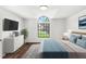 Bright bedroom with large arched window, hardwood floors, and modern decor at 400 Timbercreek N Dr, Winter Garden, FL 34787