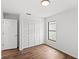 Bright bedroom features wood-look floors, a closet with louvered doors, and crisp, white walls at 400 Timbercreek N Dr, Winter Garden, FL 34787
