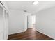Bright bedroom featuring wood-look floors, a closet with louvered doors, and crisp, white walls at 400 Timbercreek N Dr, Winter Garden, FL 34787