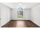 Spacious bedroom with a large arched window and wood floors at 400 Timbercreek N Dr, Winter Garden, FL 34787