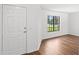 Bright entryway featuring a window and wood-look floors, enhancing the home's appeal at 400 Timbercreek N Dr, Winter Garden, FL 34787