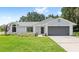 Charming single-story home with a well-manicured lawn, gray roof, and inviting curb appeal at 400 Timbercreek N Dr, Winter Garden, FL 34787
